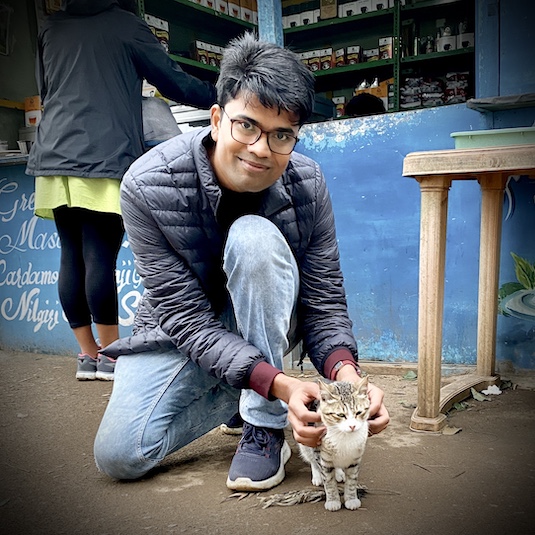Profile Picture of Adrián Moreno (@zetxek), working side by side with a colleague: sitting on a desk, while looking at a screen